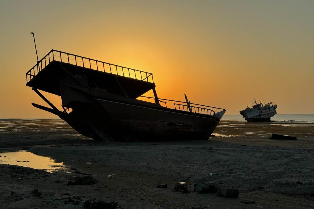 Two dhows above the tide on a beach in Masairah, Oman