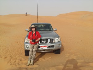 Marina resting on the bumper of her LWB Nissan Patrol