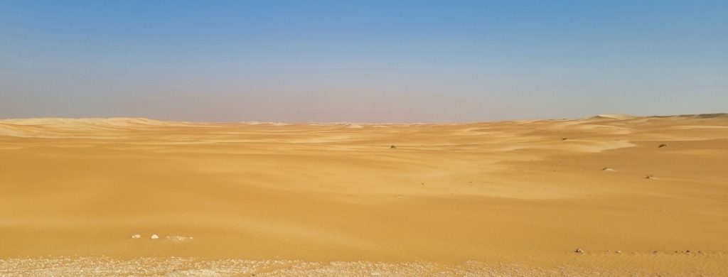 A wide shot of the Rub al Khali desert showing a flat area of sand