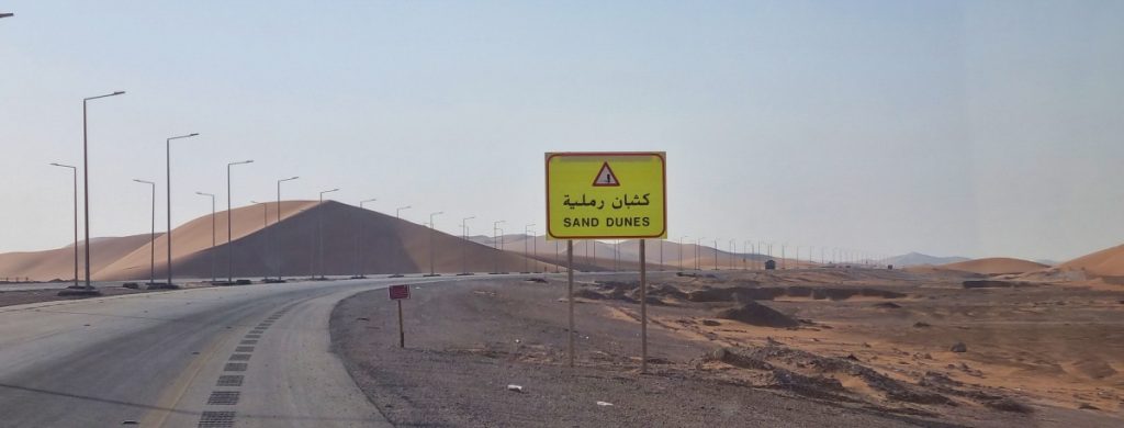 A road sign on the Rub al Khali Road gives a warning that sand can be blown over the road