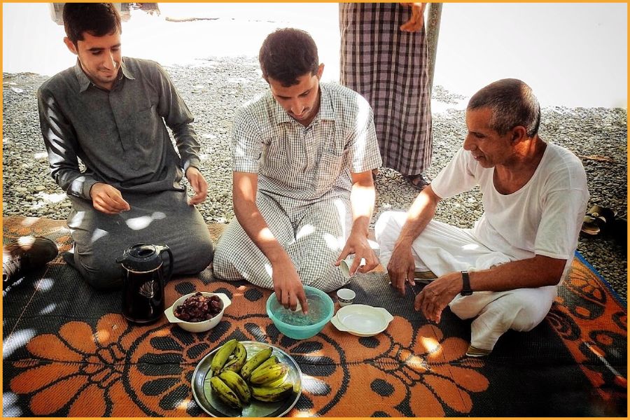 young omani men share qawa and bananas