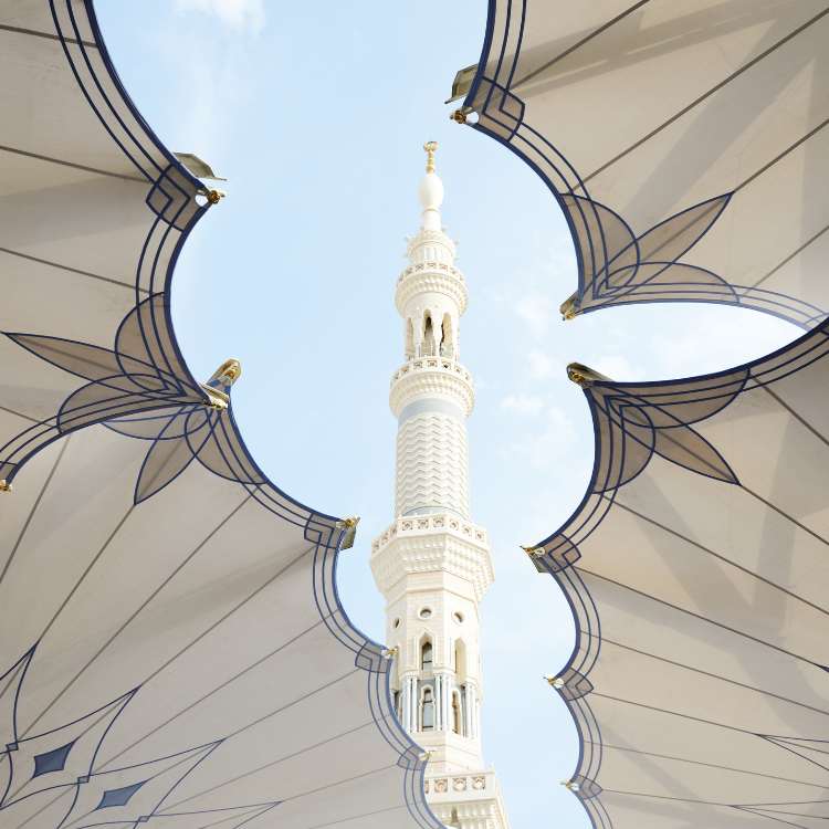 minaret and umbrellas at mosque in medinah haram