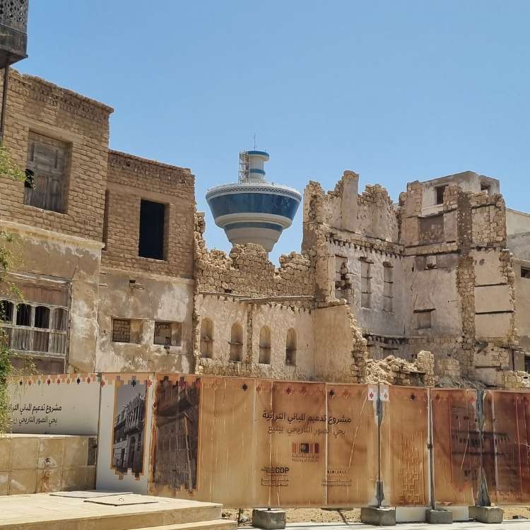 old buildings with a modern tower behind them